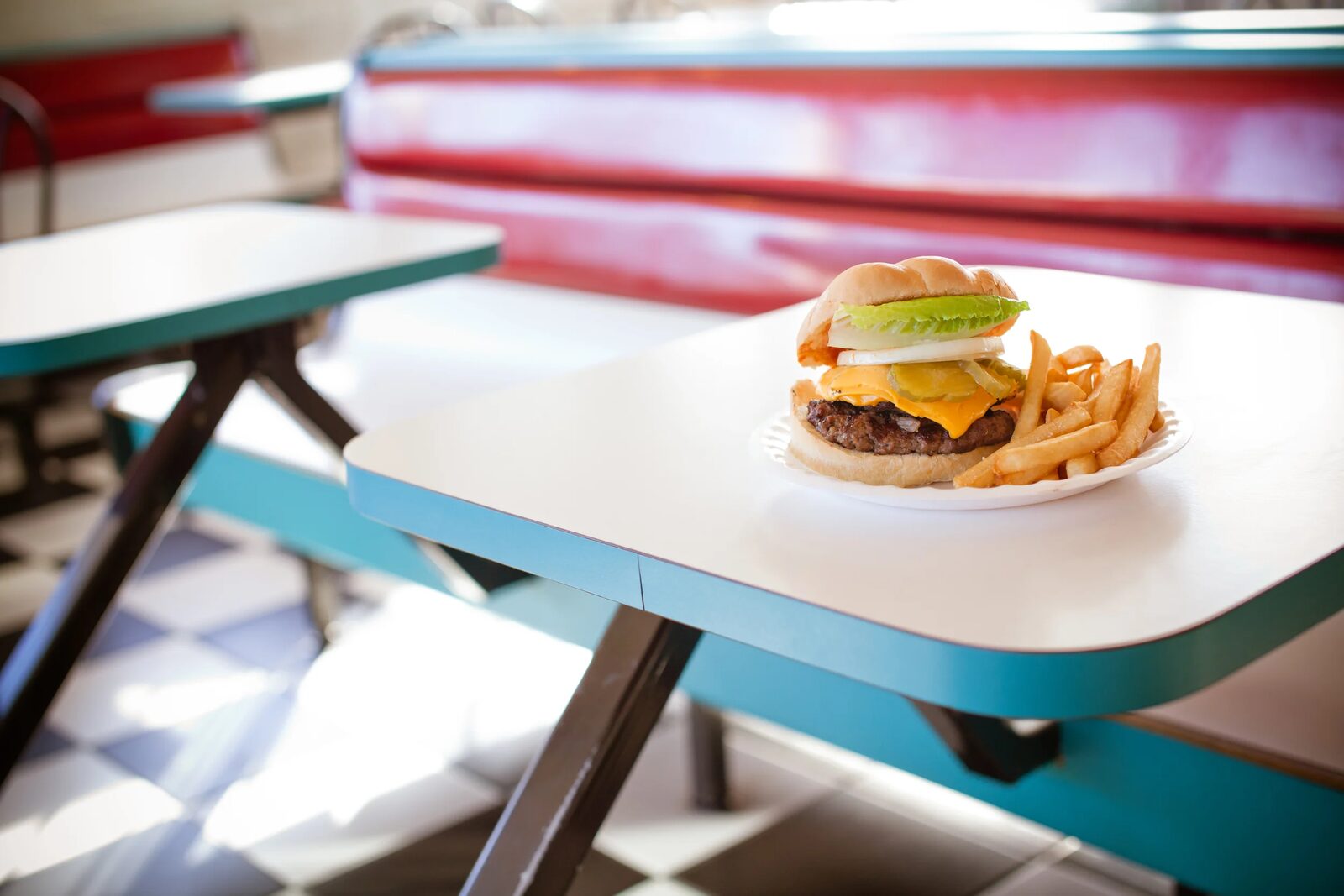BBQ burger with fries on a diner table