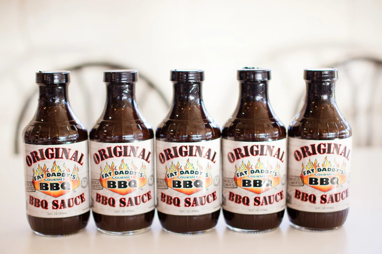 A lineup of Fat Daddy's Original BBQ Sauce bottles